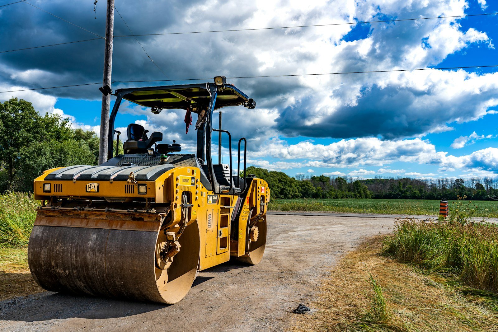 Parked asphalt road roller with an empty operator seat