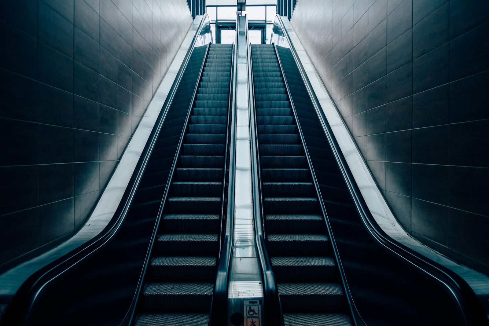 Escalator steps and machinery – reference Parallel escalators showing stainless steel steps and side panels