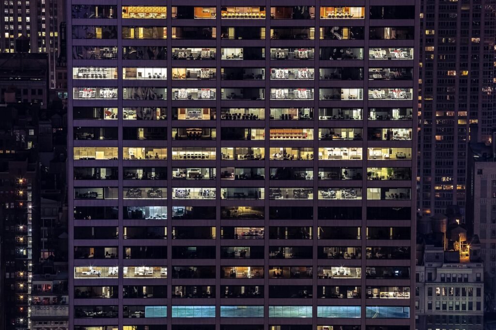 Office building with illuminated work areas at night