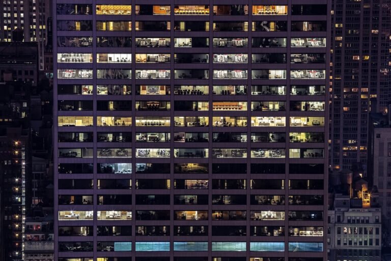 Office building with illuminated work areas at night