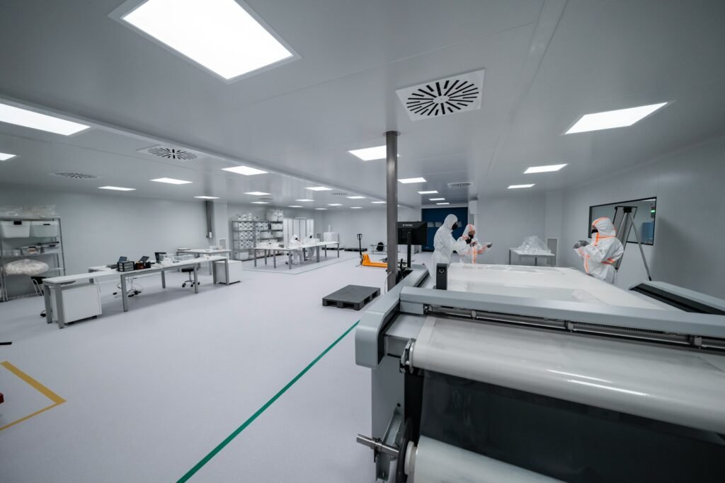 Cleanroom production equipment Production equipment and operators wearing protective clothing in a cleanroom